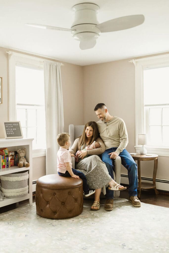 Family with toddler and newborn during lifestyle newborn session in Cumberland Rhode Island nursery